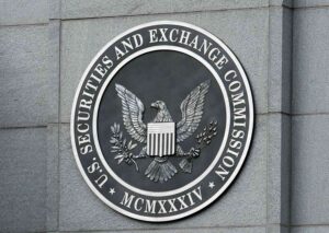 A close-up of the Securities and Exchange Commission (SEC) seal on a grey stone wall, symbolizing financial regulation and oversight in the United States.