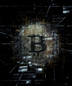 A close-up of a golden Bitcoin coin placed on a computer motherboard, representing the connection between cryptocurrency, blockchain technology, and digital finance.